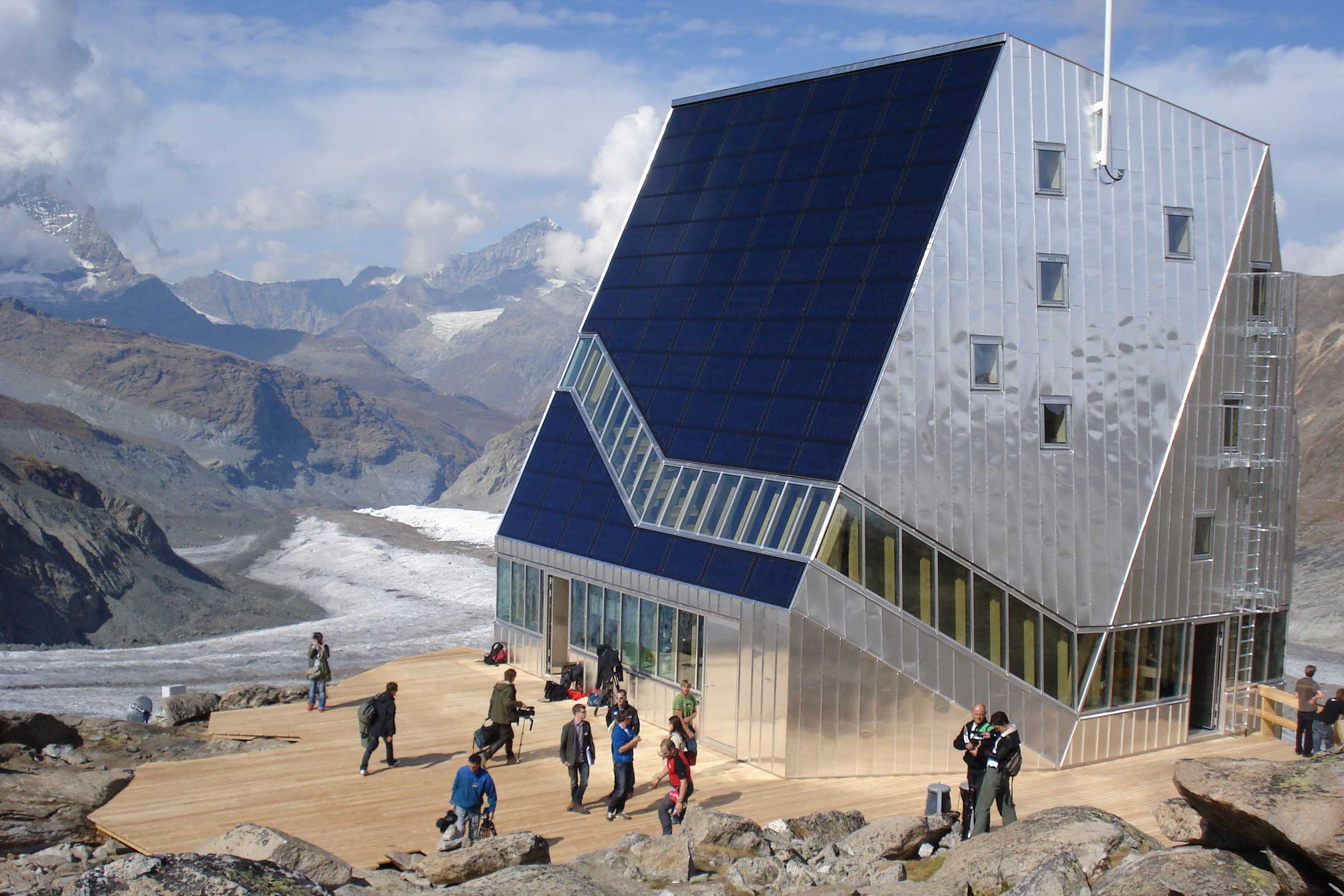 group of people on the exterior decking of the Monte Rosa Hut